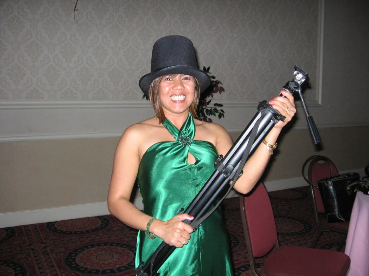 woman with a gun in a hat and gown