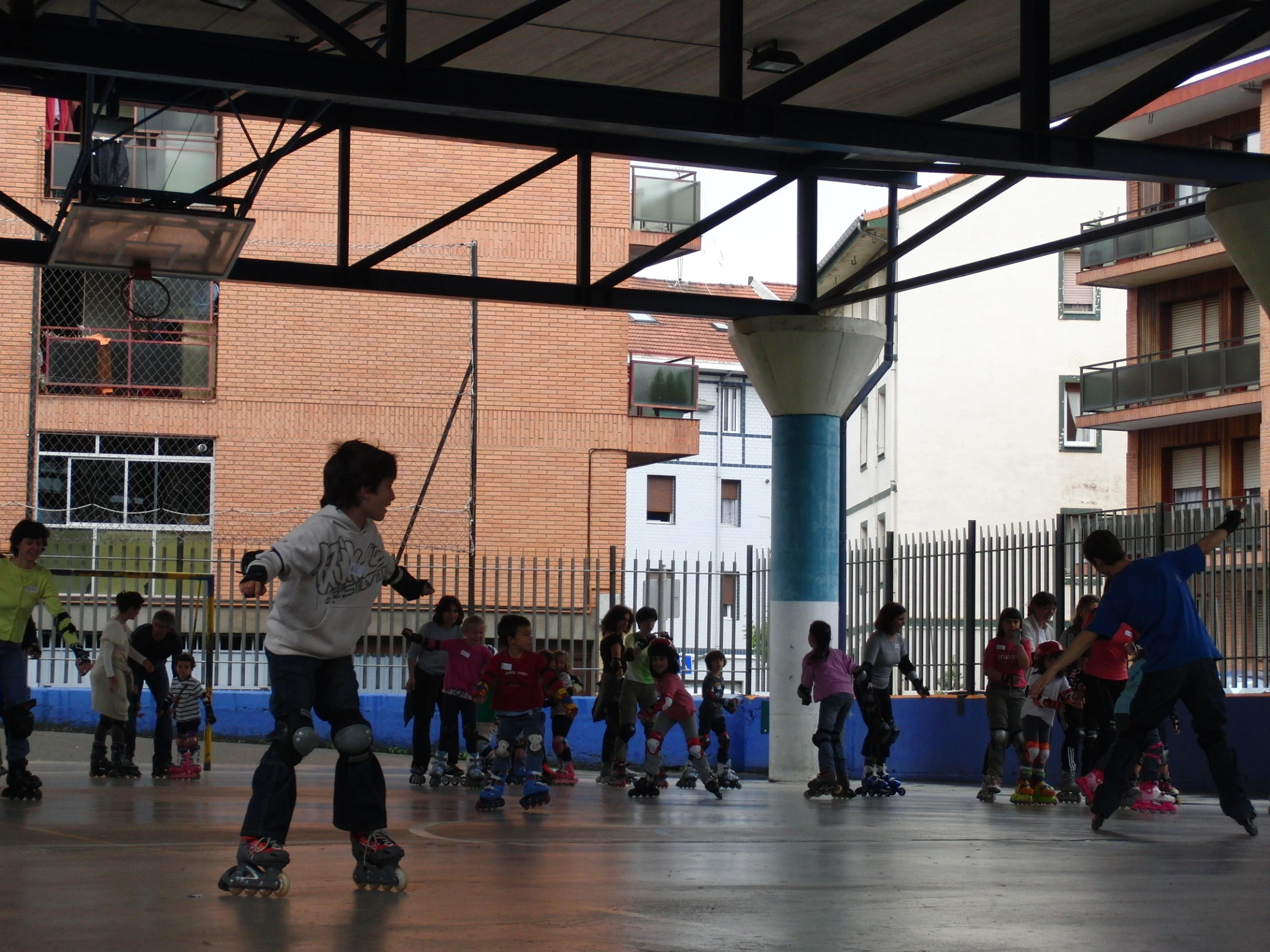 s standing in a courtyard skateboarding together