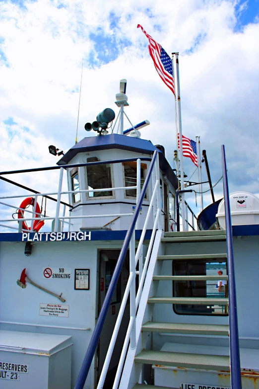 a boat with stairs leading to a light pole