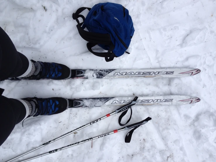 the feet are in the snow with skiing equipment