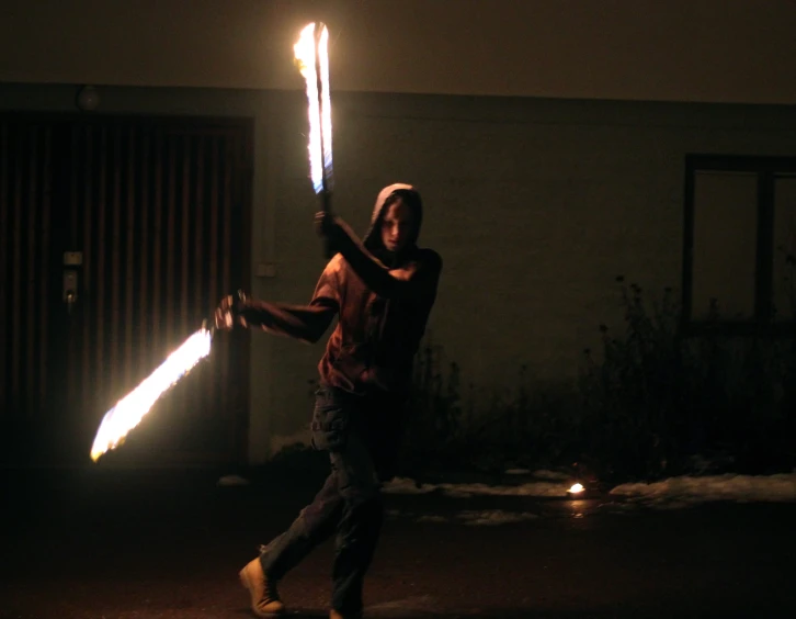 a man holding two lightsabed on his arm