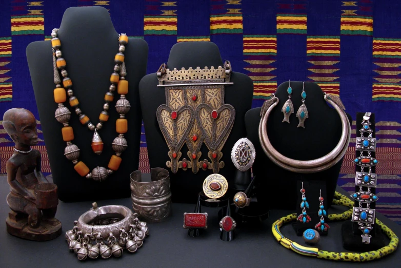 a collection of jewelry sitting on top of a counter