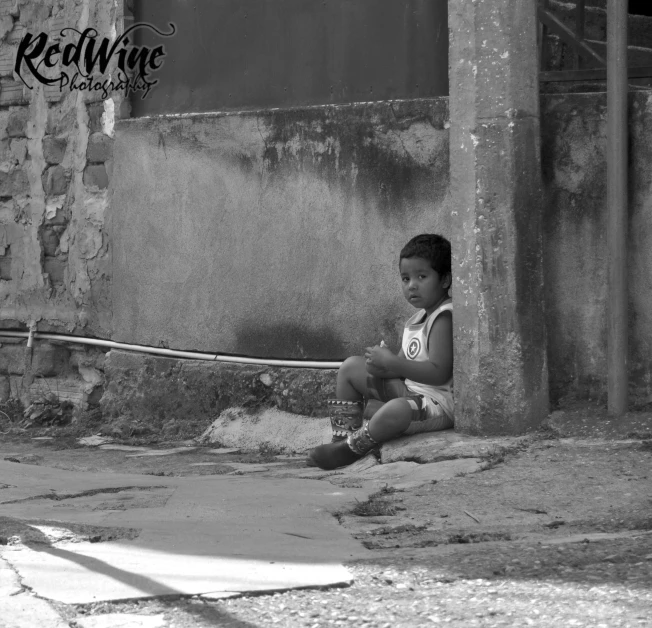 black and white pograph of small child with a baseball bat