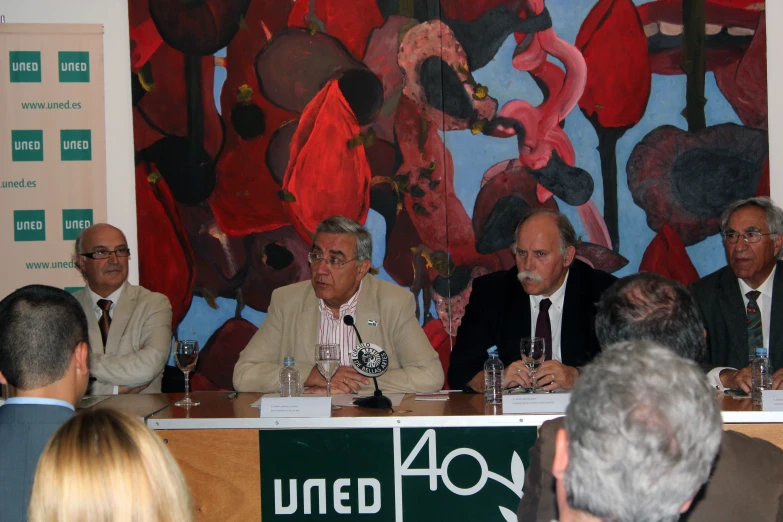 several men at a panel for the international center