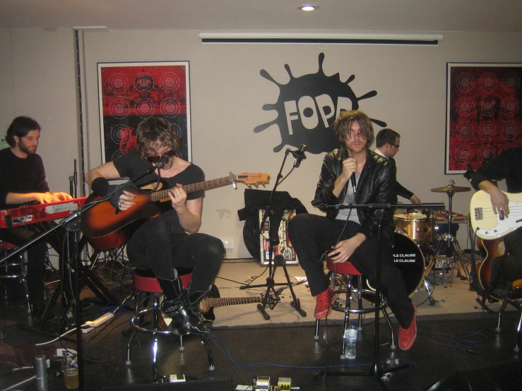 a group of people playing guitar in an office