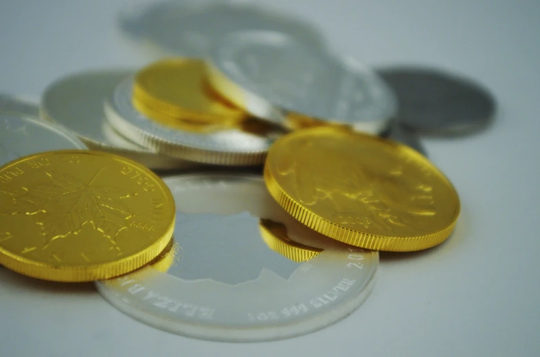 a close up of four british coins on a table