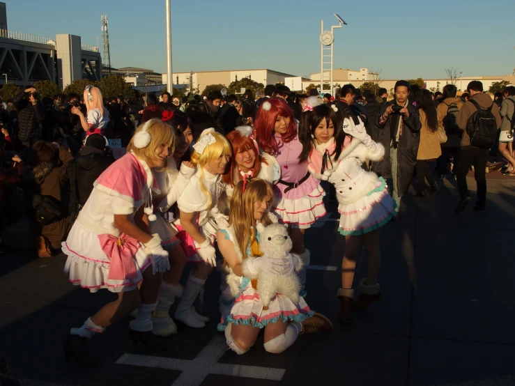 many young women dressed up like cats and dogs on the sidewalk