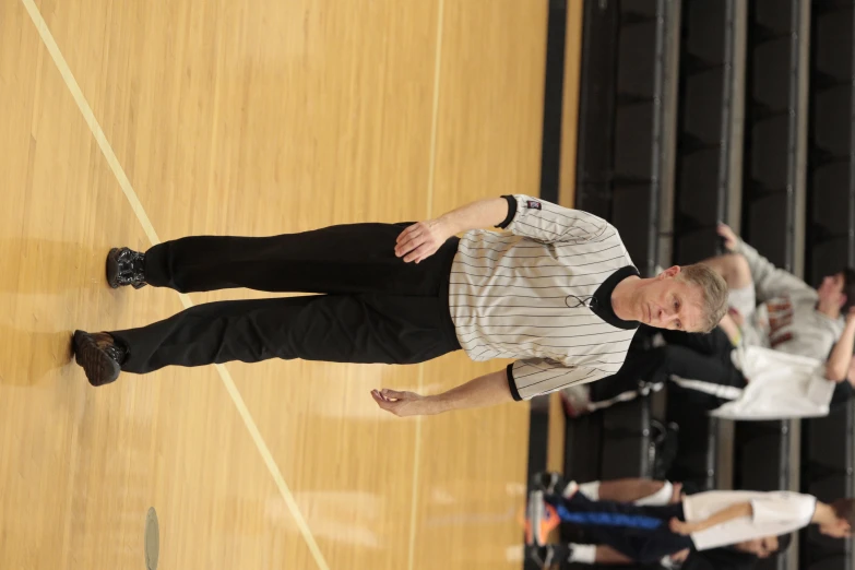 a male basketball player is on the court with others