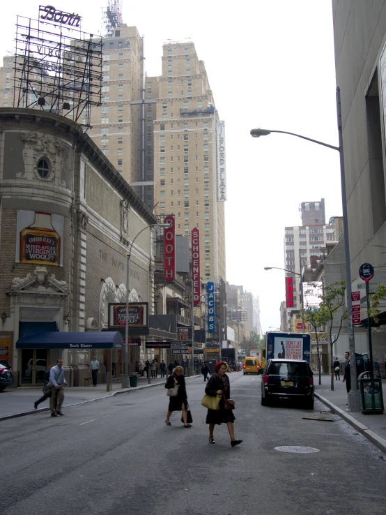 people crossing a street on the road in the city