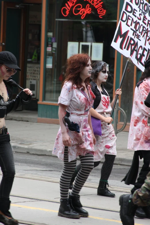 the group of women are dressed up as zombies