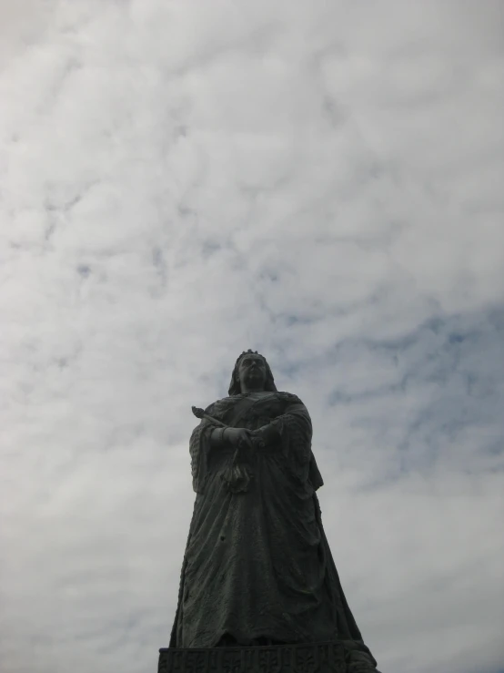 statue of mother nature against cloudy sky