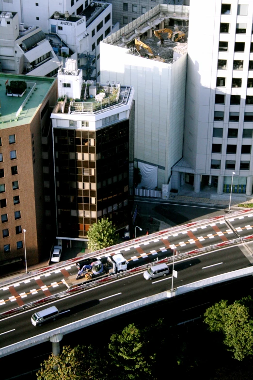 a freeway with lots of cars and tall buildings in the background