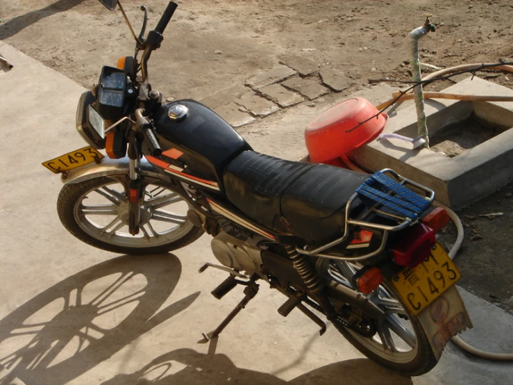 a motorcycle parked next to a gas tank