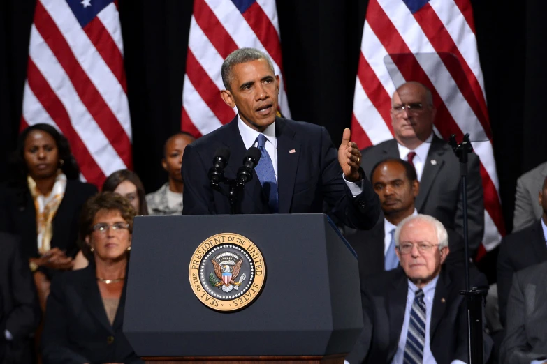 obama makes a speech in front of some people