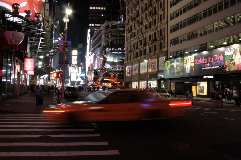 a car speeding past an intersection in the night