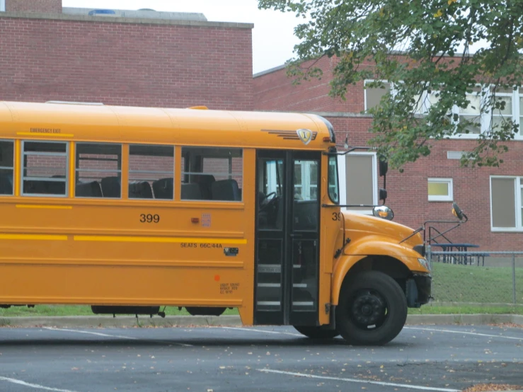 an orange bus parked by a red brick building