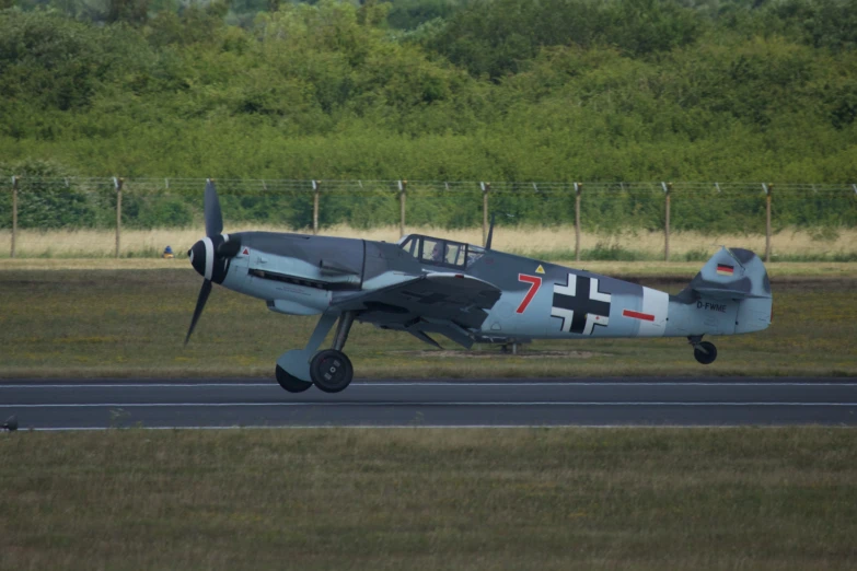 a plane on an air field on a cloudy day