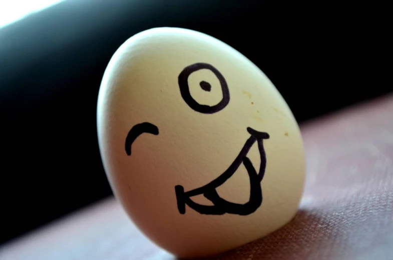 an egg with a smiley face drawn on it's side