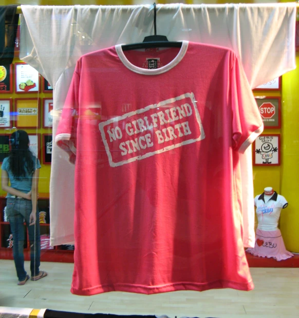 a t - shirt hanging in a store for women