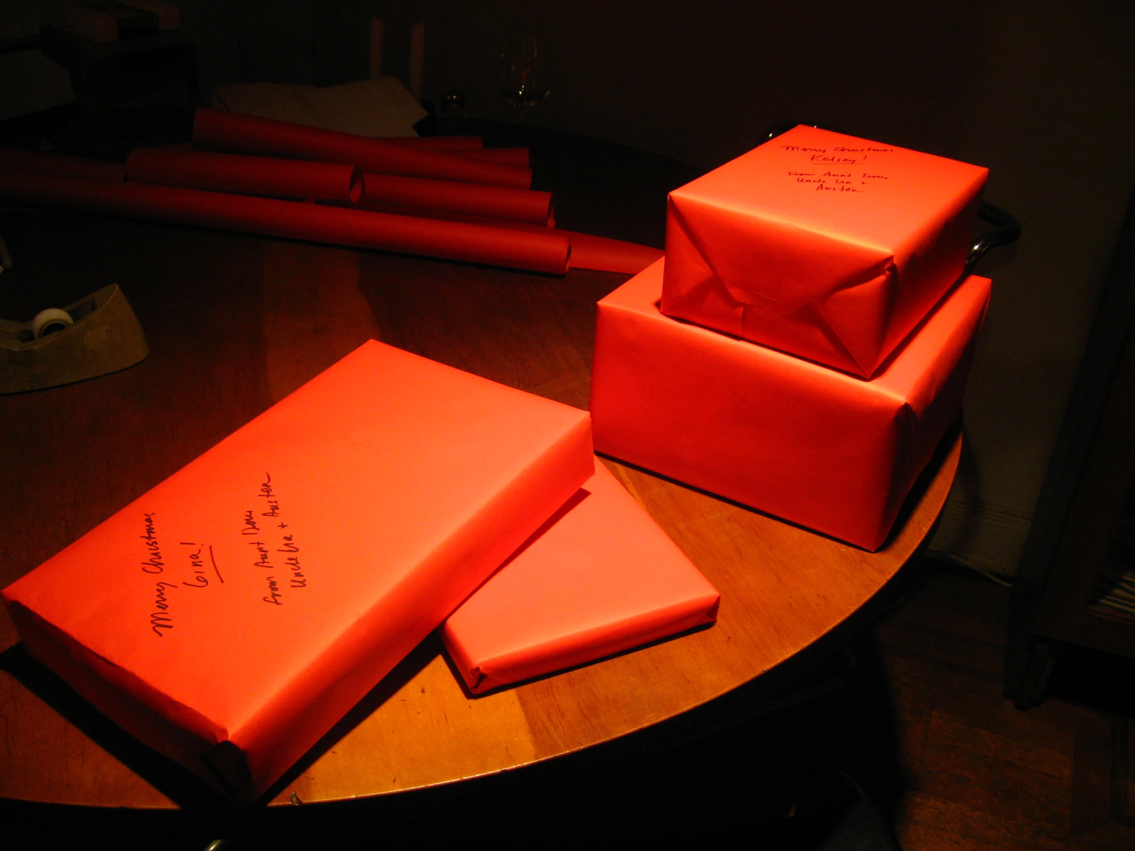 four books are displayed on the table, one red