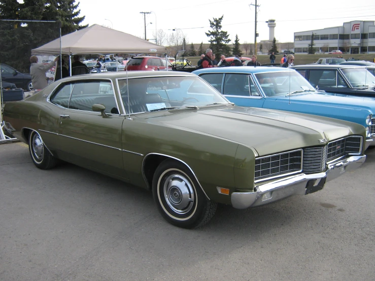 some classic cars are parked near one another