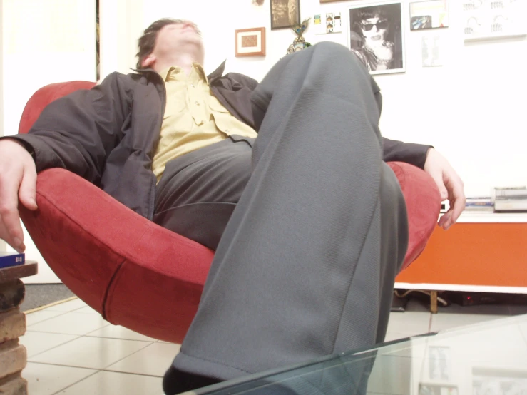 man resting in his feet on the office chair