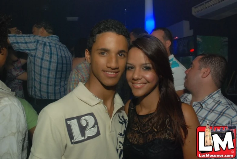 the young man and woman are posing for a picture together