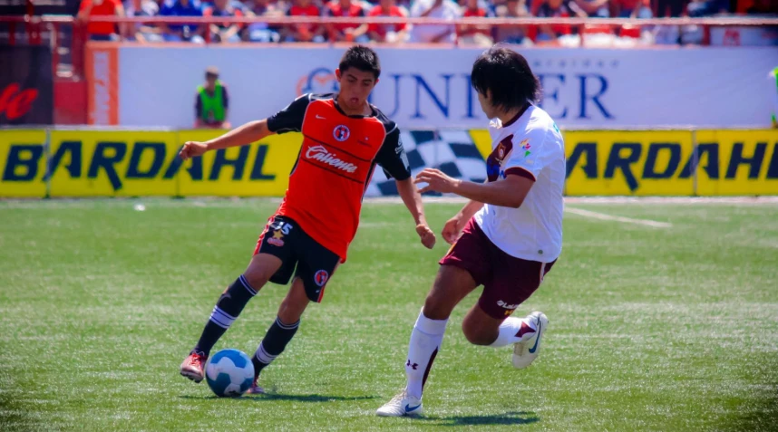 two soccer players fight for control of the ball