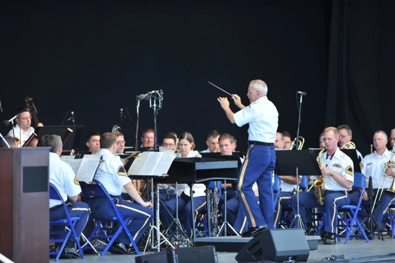 the musicians with the music director look on