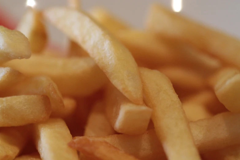 closeup of french fries with the lit candles