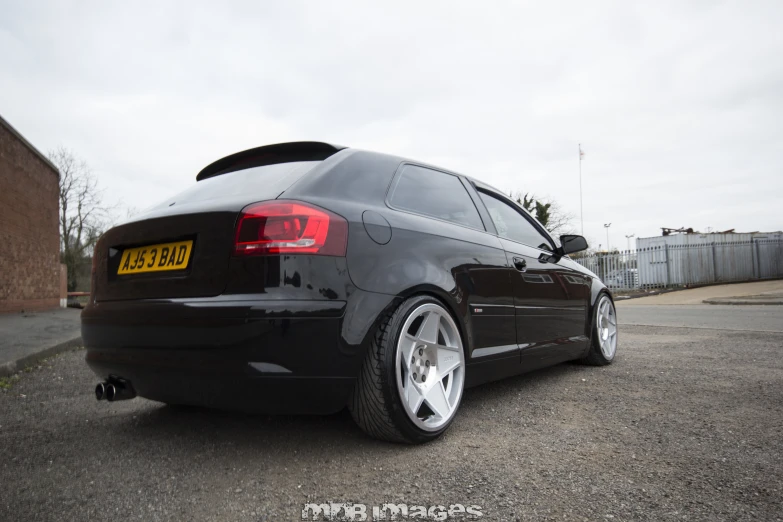 the rear view of a car with wheels parked