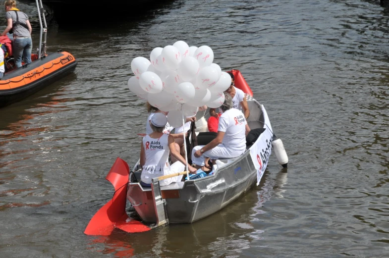 two people are riding a boat with balloons