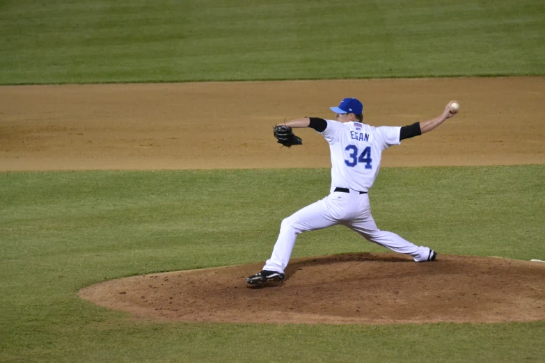 baseball pitcher winds up for the pitch