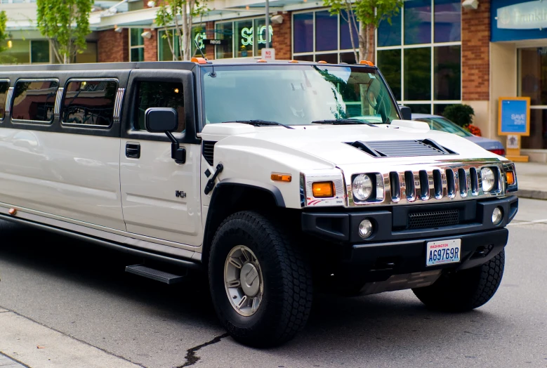 a large white hummer with an empty side window