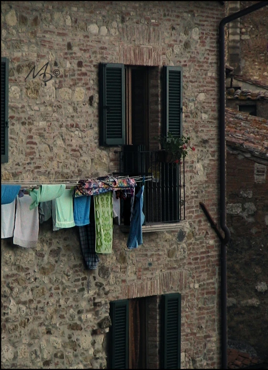 clothes hanging on a clothes line next to an old building