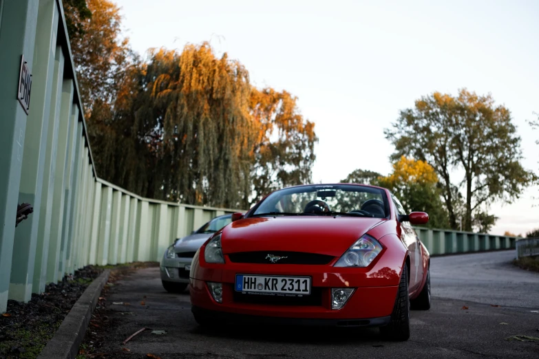 a car is parked next to a wall