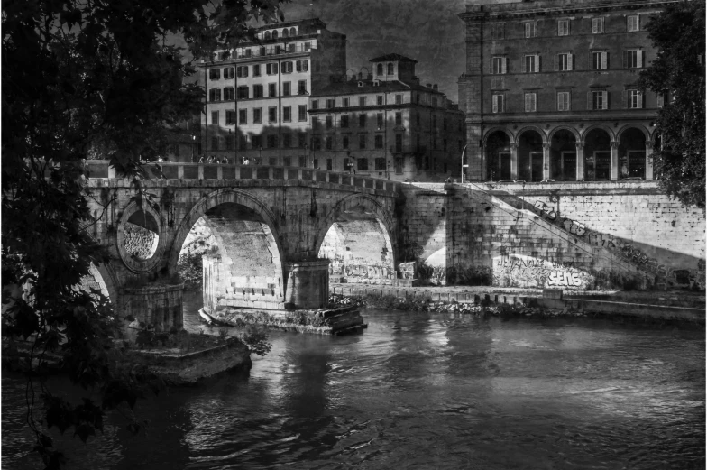 a bridge crossing the water with buildings in the background