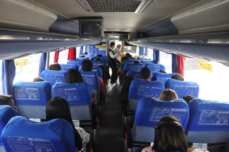 a view from the back seat of a bus with passengers