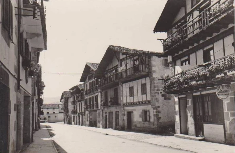 a black and white pograph of a town street