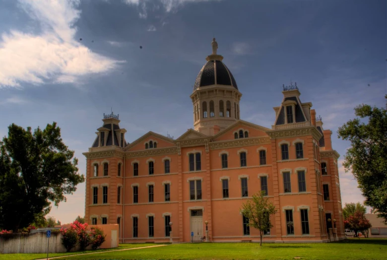 this is the back of an old courthouse building with clocks on top