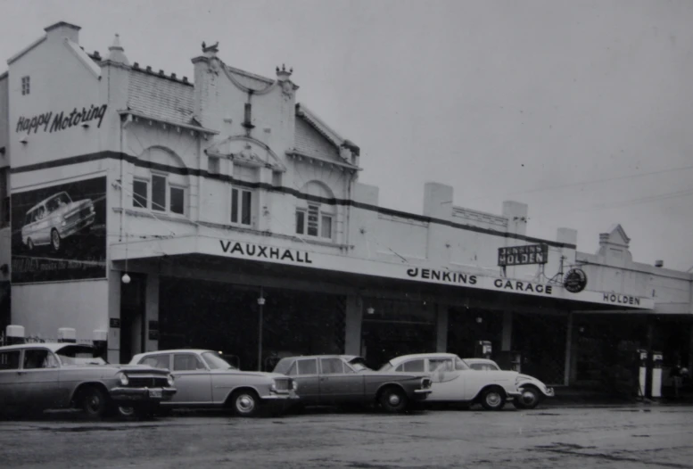 an old po of a bunch of cars parked outside