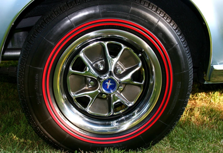 the tire of a blue car with red stripes on it