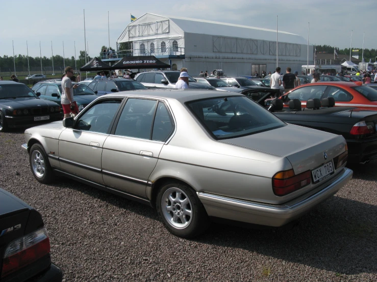 a group of cars parked outside at a car show