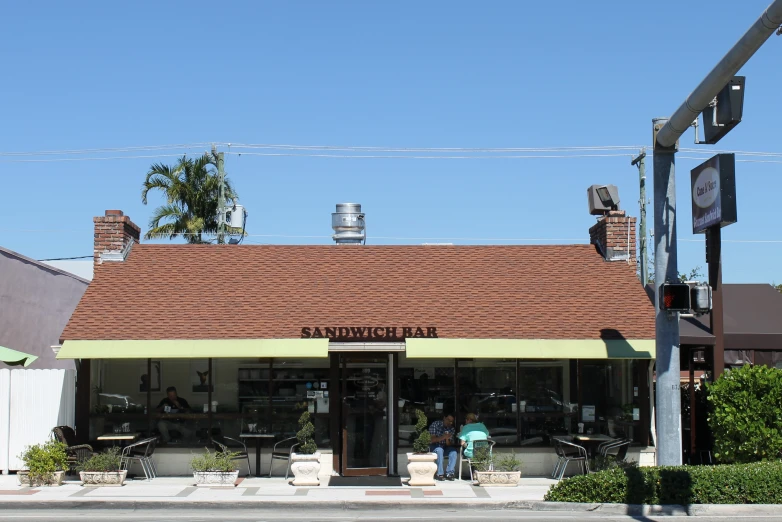 the corner store has red roofs and brown tile