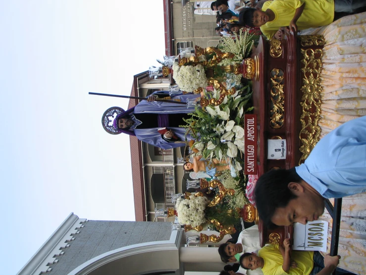 the man in blue is riding on top of the float