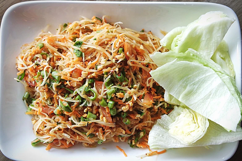 a white plate topped with cabbage and vegetable