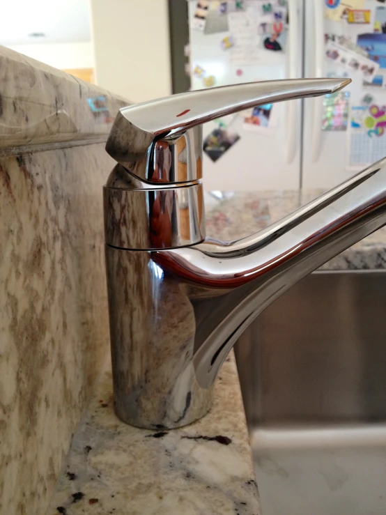 a faucet in a kitchen next to a sink