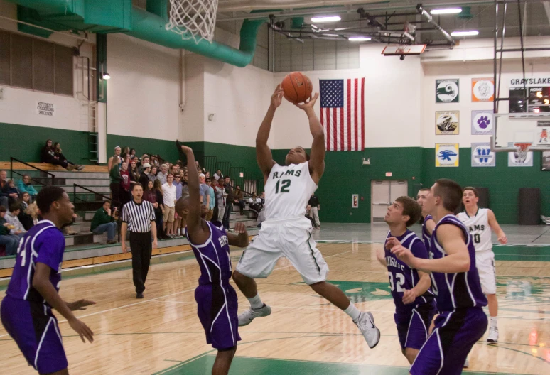 a man trying to get a dunk in a basketball game