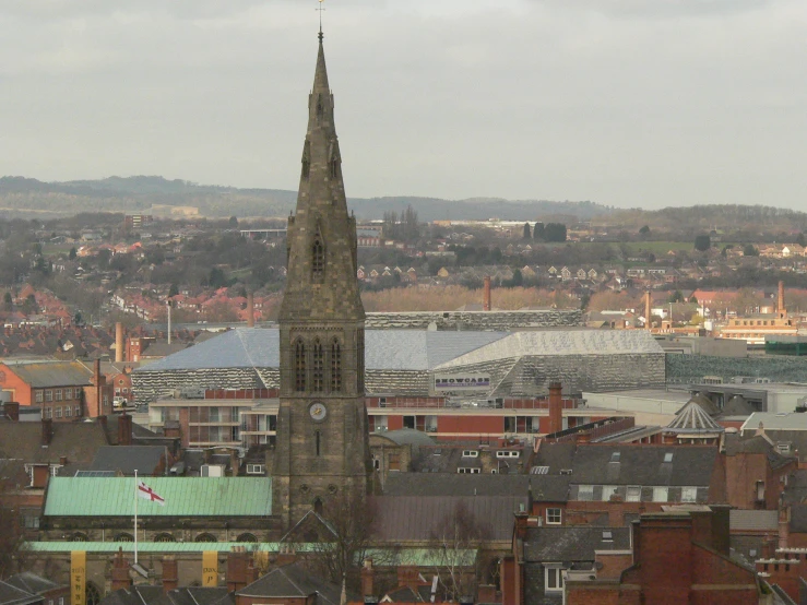 large tower with a clock on top of buildings