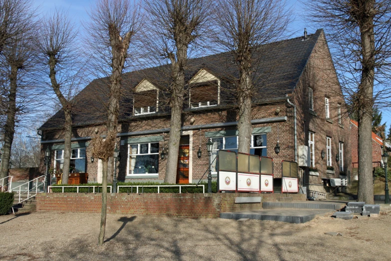 an old building with many trees in front